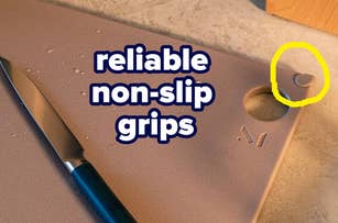 Close-up of a cutting board with a knife, featuring non-slip grips and water droplets, highlighting durability and functionality for kitchen use