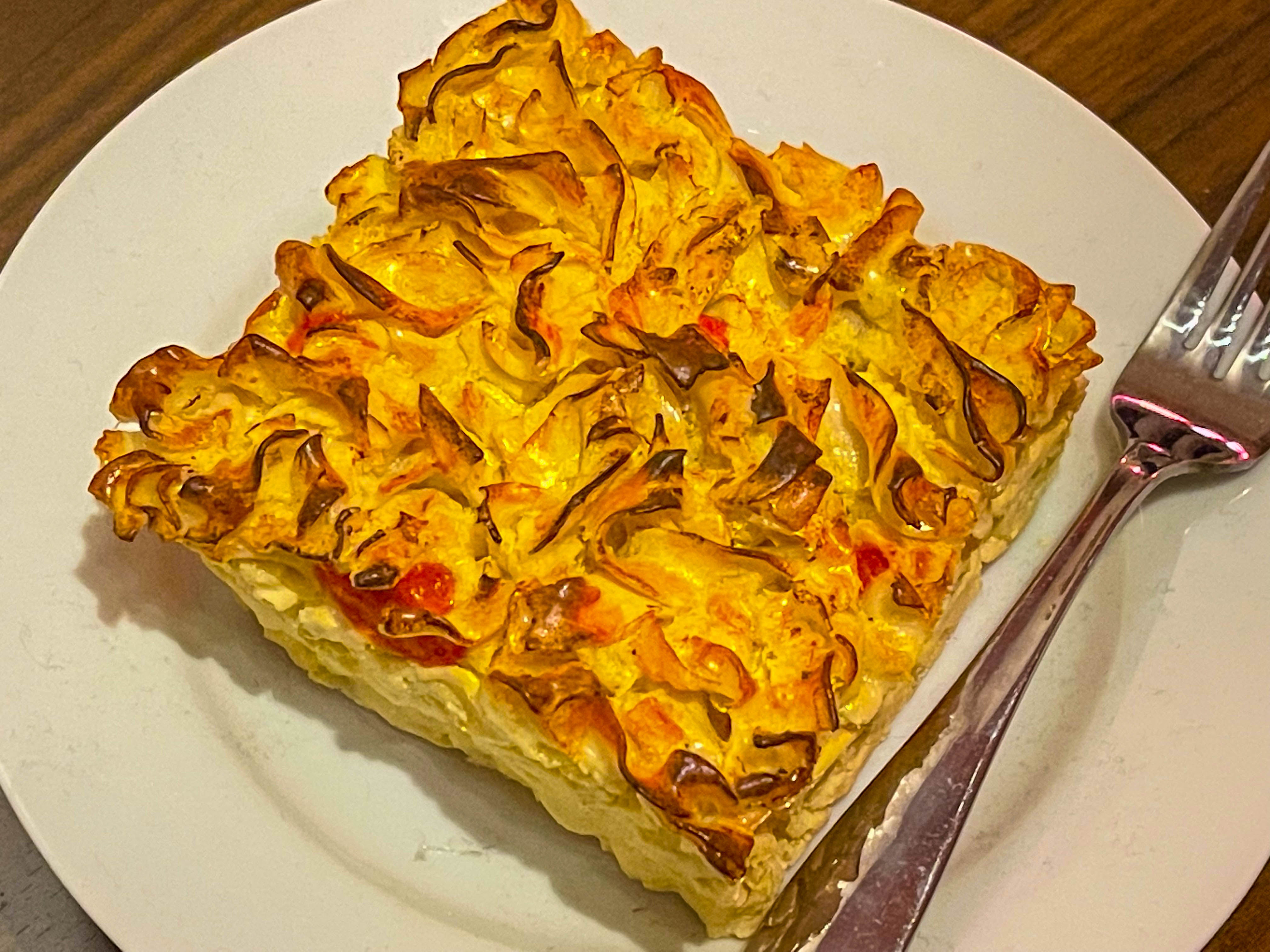 Crispy noodle kugel on a white plate