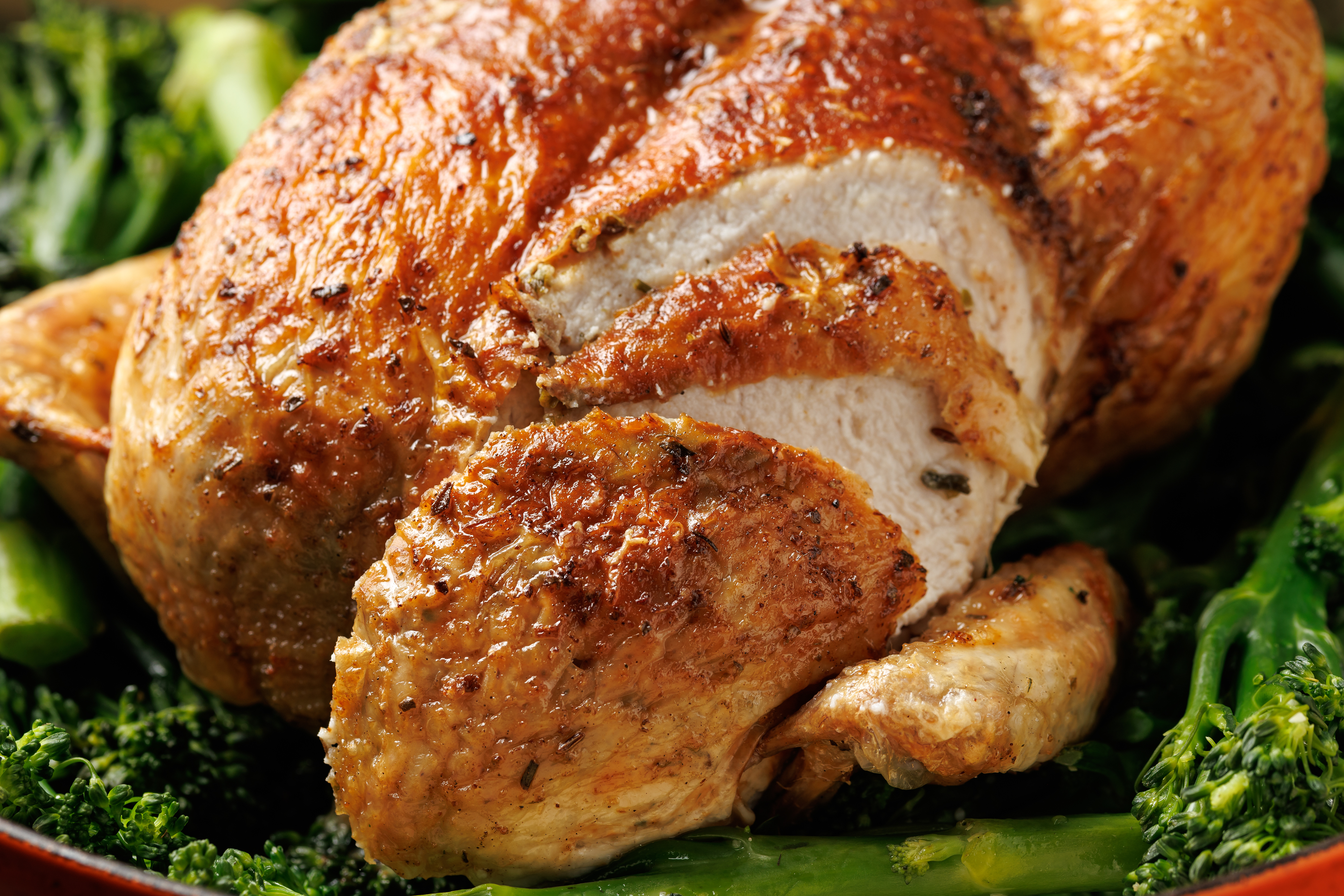 A close-up image of seasoned rotisserie chicken