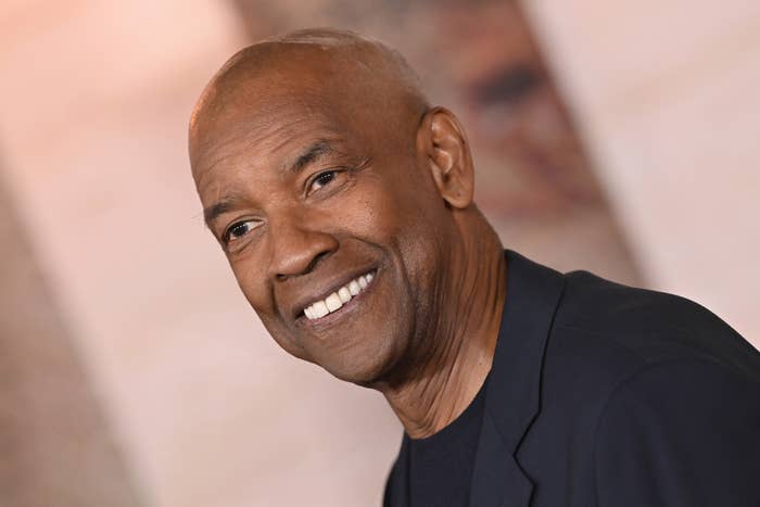 Denzel Washington in a suit jacket at a public event, seemingly posing for photos