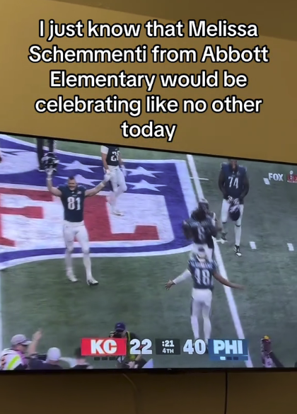 Scene of a football game on TV. Text overlay jokes about a character named Melissa Schemmenti from Abbott Elementary celebrating a specific event