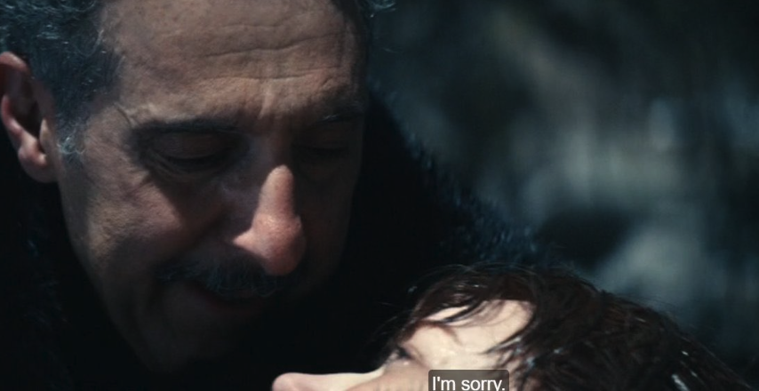 Irving tenderly looks at Helly lying down, with subtitles reading "I'm sorry."
