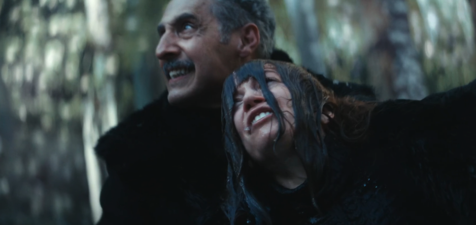 Irving and Helena looking up, both wearing dark fur outfits after Irving has pulled her out of the water