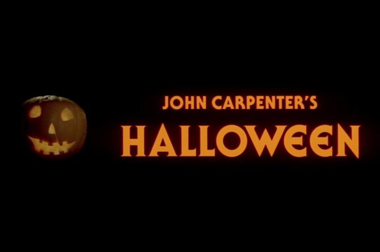 Jack-o'-lantern with "John Carpenter's Halloween" text, black background. Iconic horror film title screen