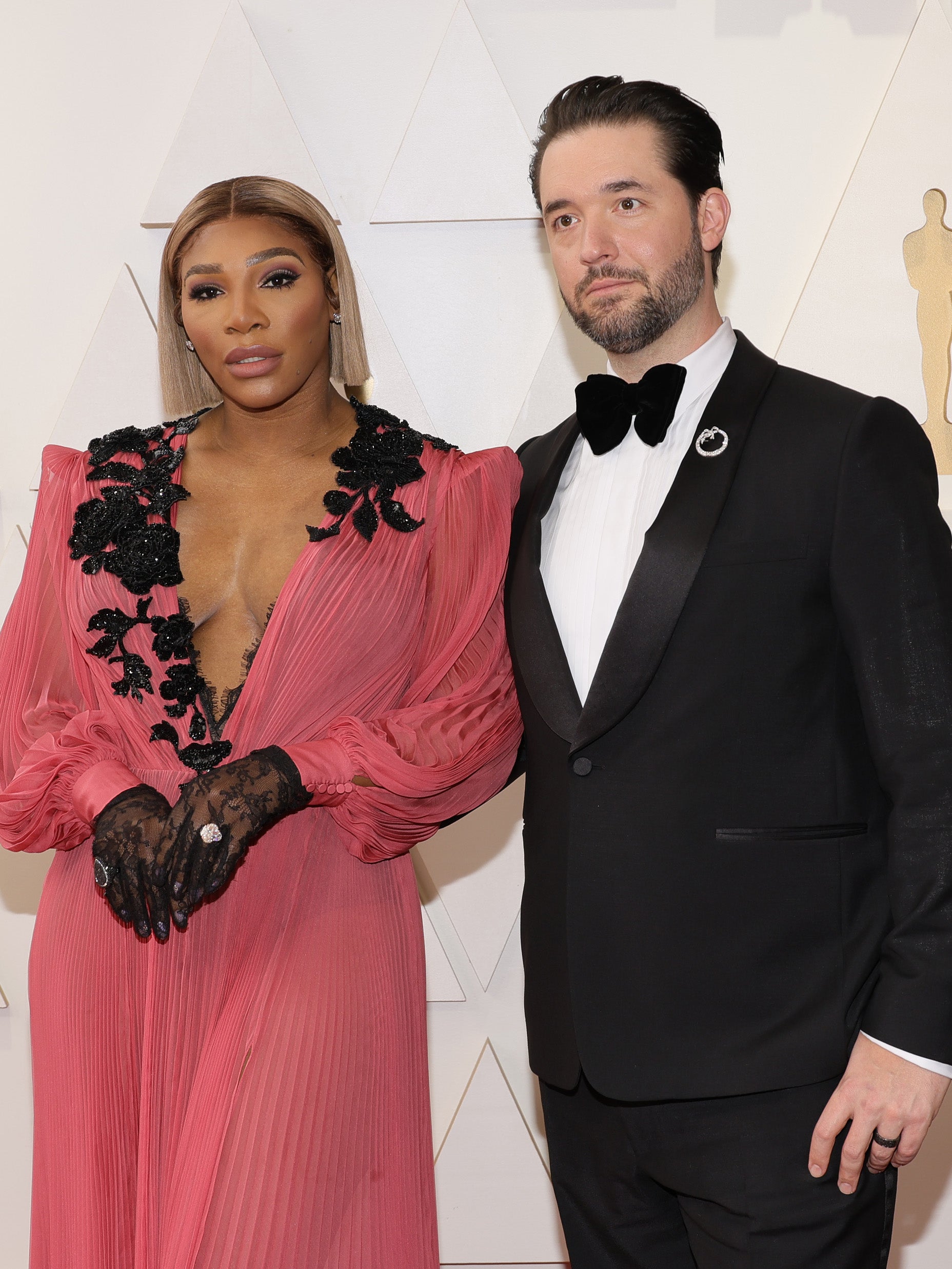 Serena Williams and Alexis Ohanian pose on a red carpet