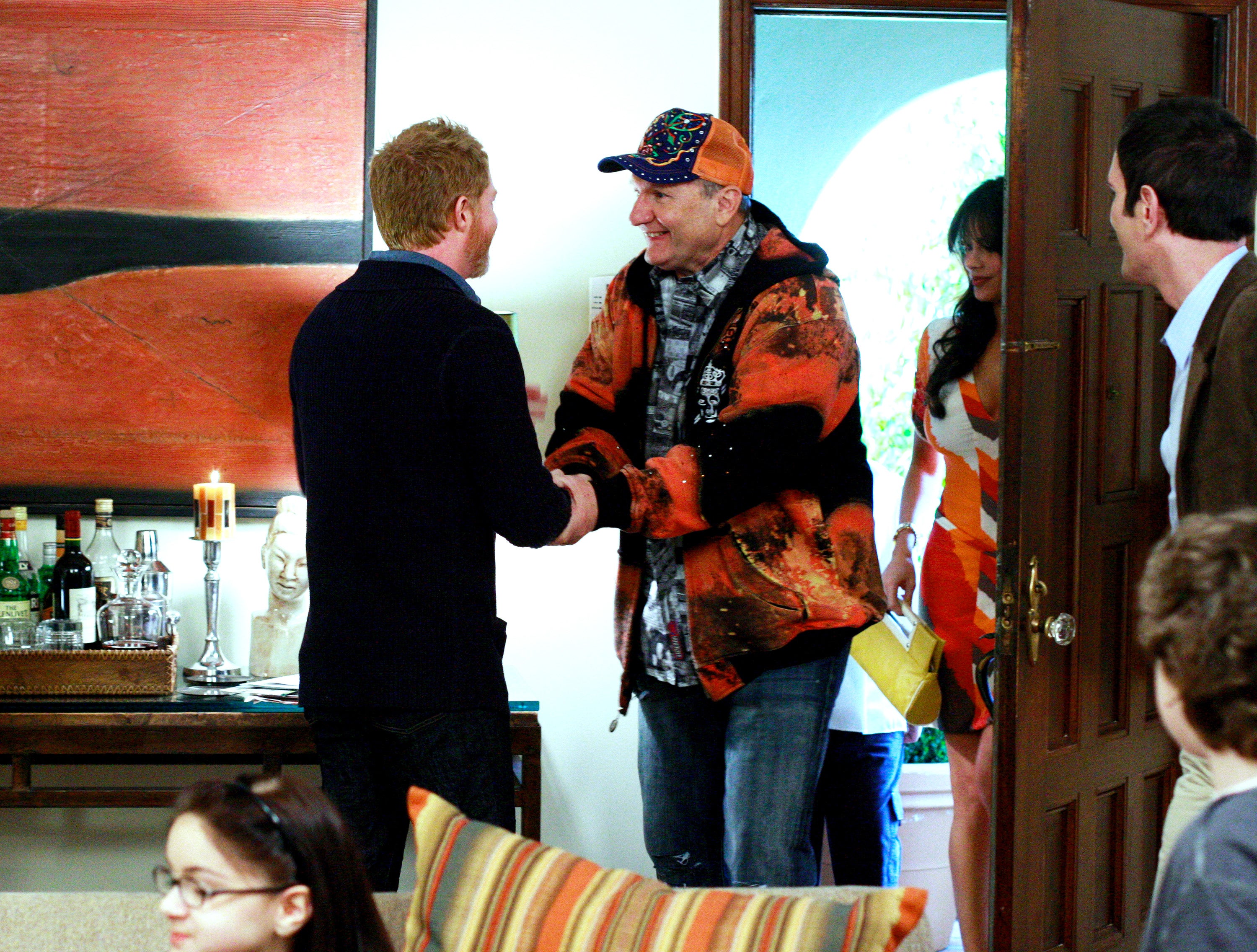 Scene from "Modern Family" with characters greeting each other in a living room