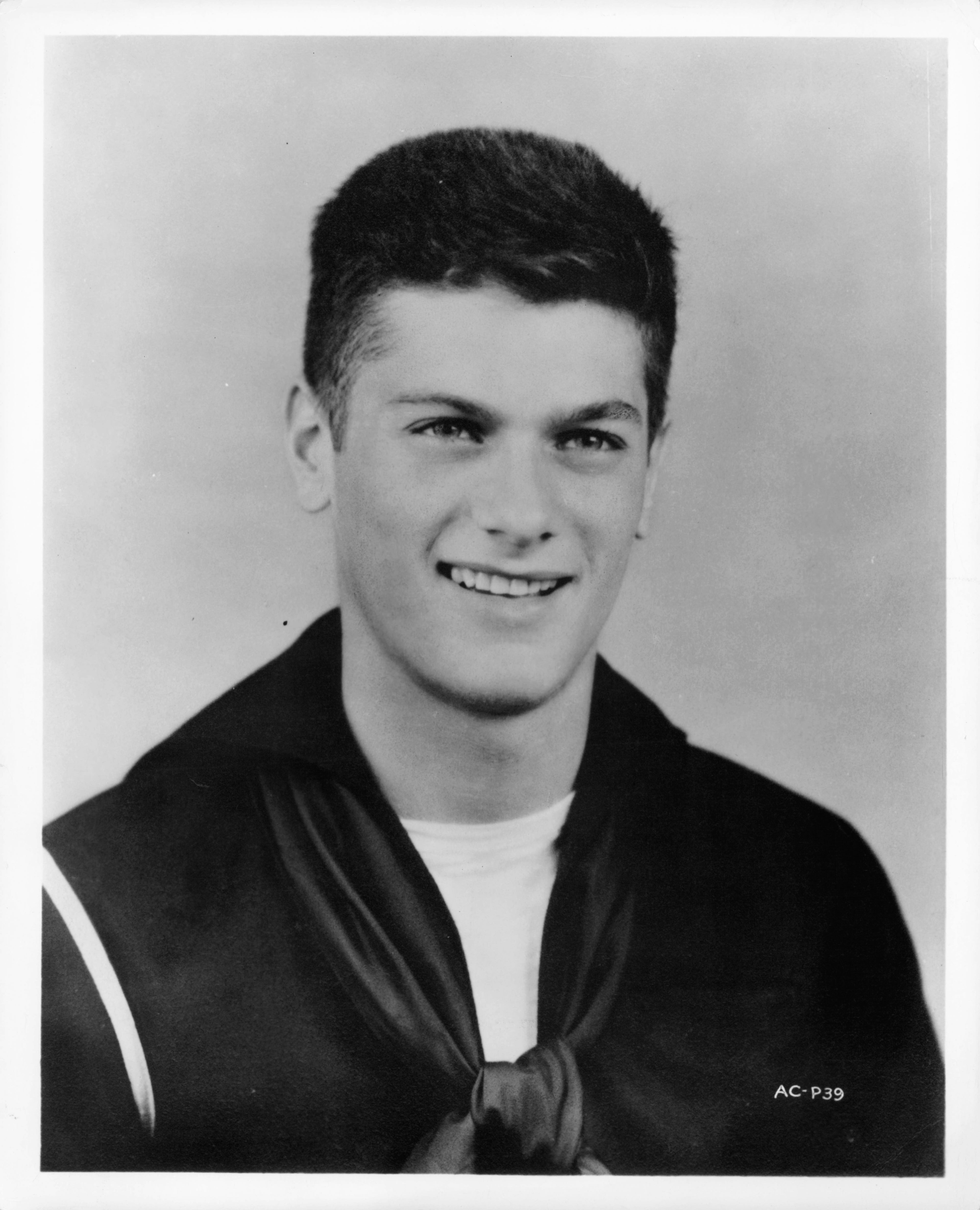 A person in a sailor outfit, smiling at the camera
