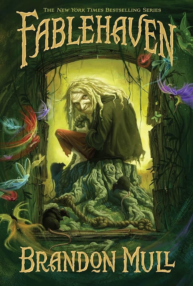 Book cover of &quot;Fablehaven&quot; by Brandon Mull features a troll-like creature sitting on a tree trunk with colorful, glowing fairies surrounding it