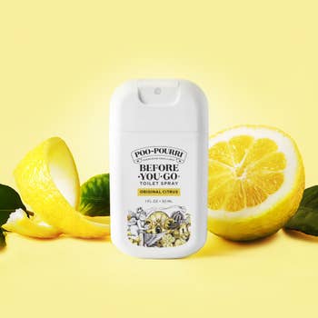 Poo-Pourri Original Citrus toilet spray vessel with full and sliced lemon, against a plain background. Featured successful buying article