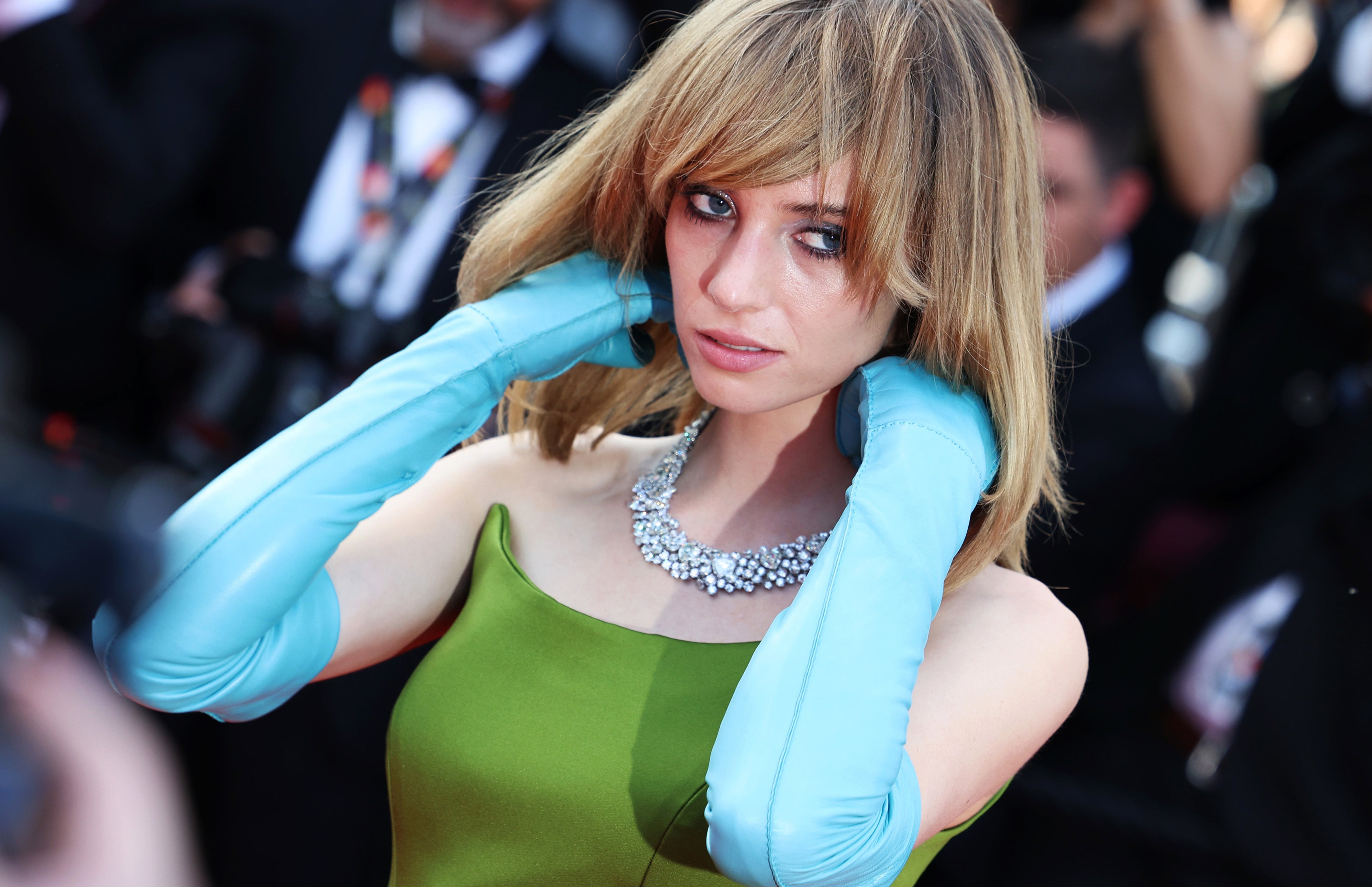 Maya Hawke in elegant gown with sparkling necklace and long gloves, on red carpet