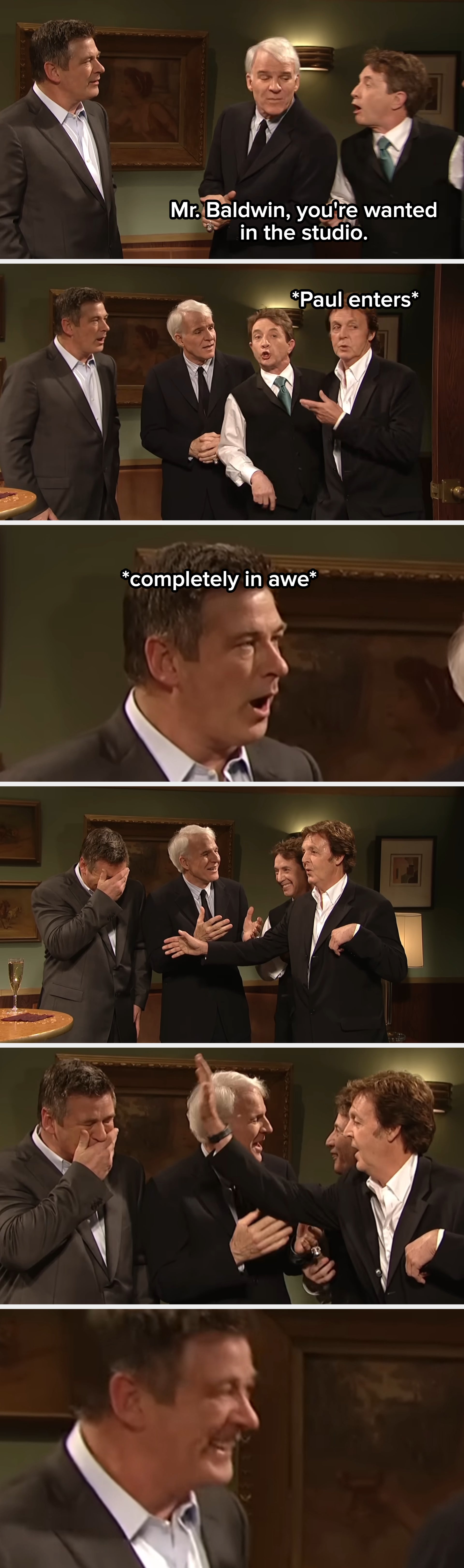 Three people are indoors in a comedic scene, wearing suits. One appears to be speaking animatedly to the others