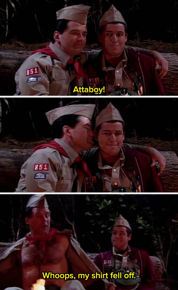 Two characters in scout uniforms, one hugging the other, then revealing a message on his chest by a campfire