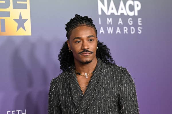 Person in textured suit poses at NAACP Image Awards