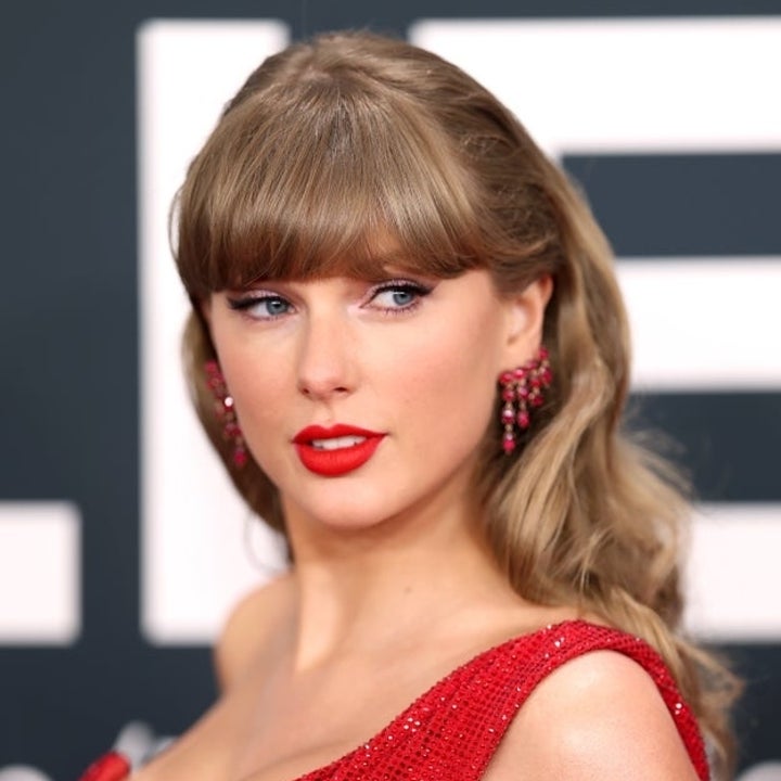 Taylor Swift in an elegant sequined dress poses on a red carpet