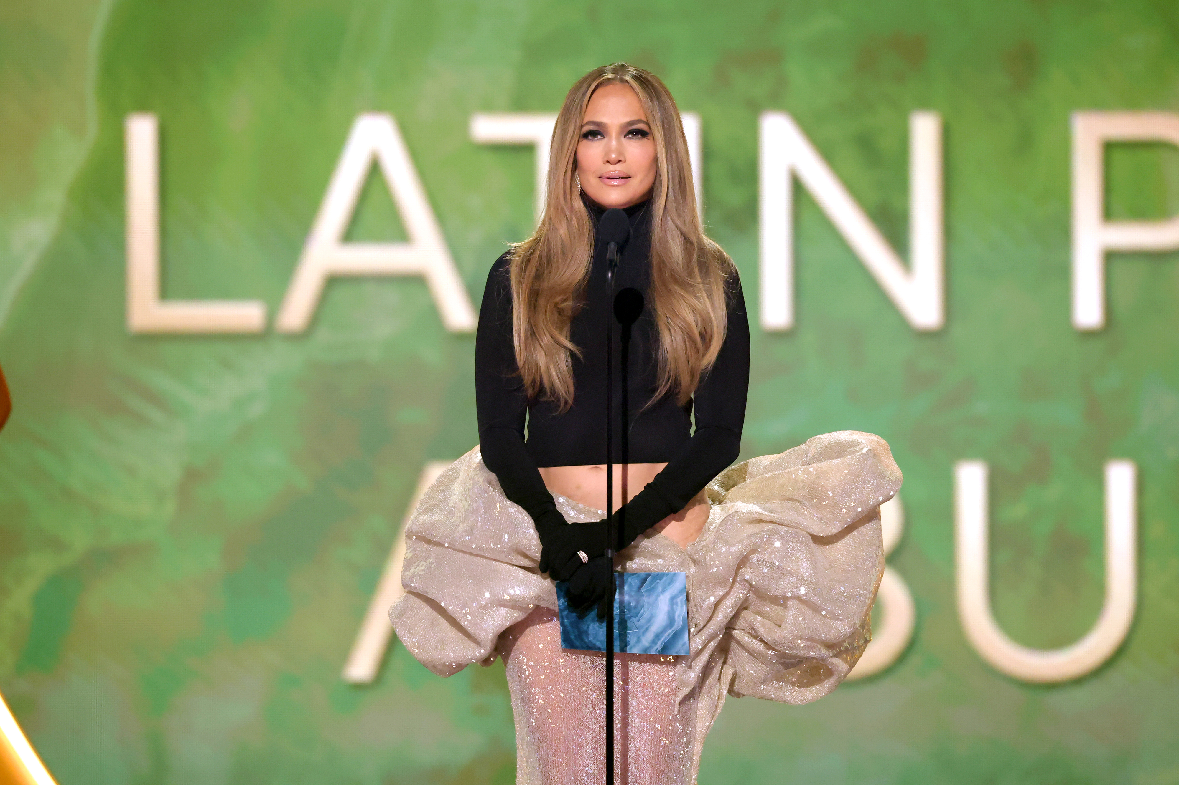 Jennifer Lopez at Grammy Awards stage presenting award.