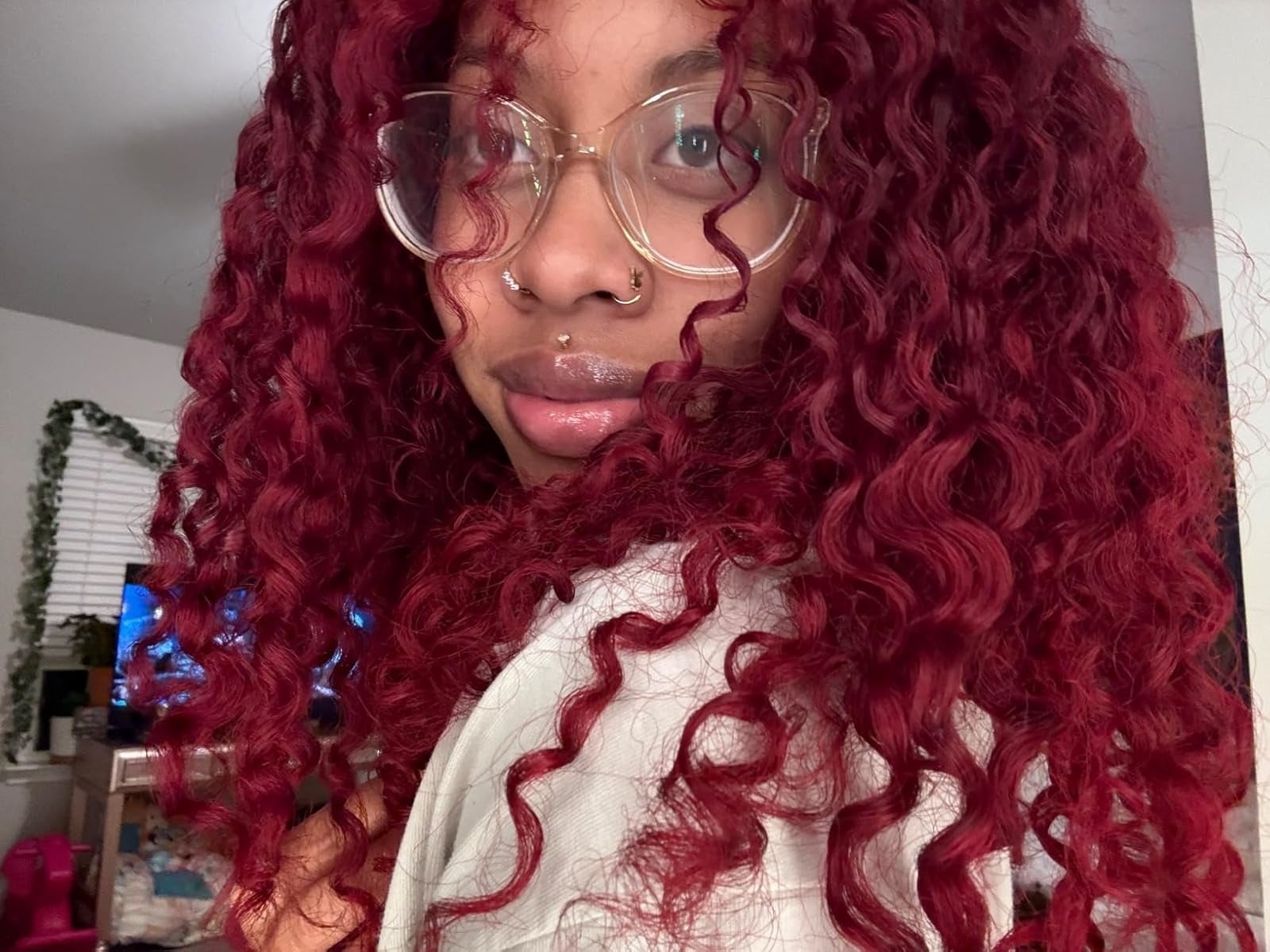 reviewer's bright red hair after using the color depositing mask