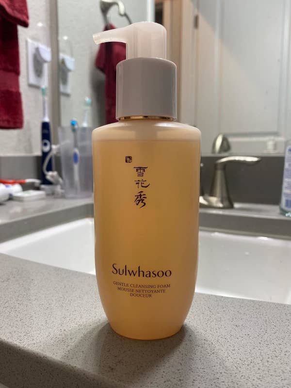 Sulwhasoo Gentle Cleansing Foam bottle on a bathroom counter with a sink in the background