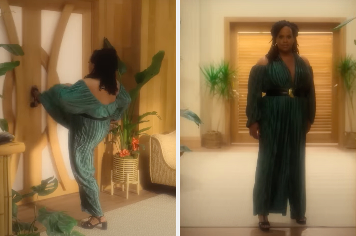 Person in a stylish, flowing jumpsuit with wide sleeves, standing and opening a door, indoors with tropical plants