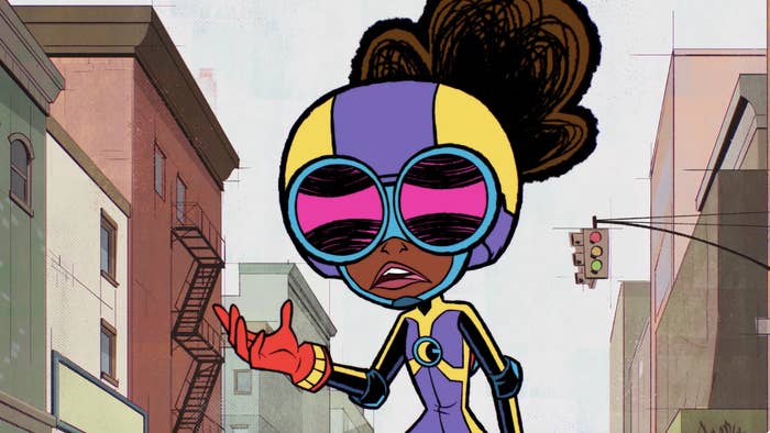 Animated character in a superhero outfit with large goggles, mid-speech, in an urban setting. Buildings and a traffic light are in the background