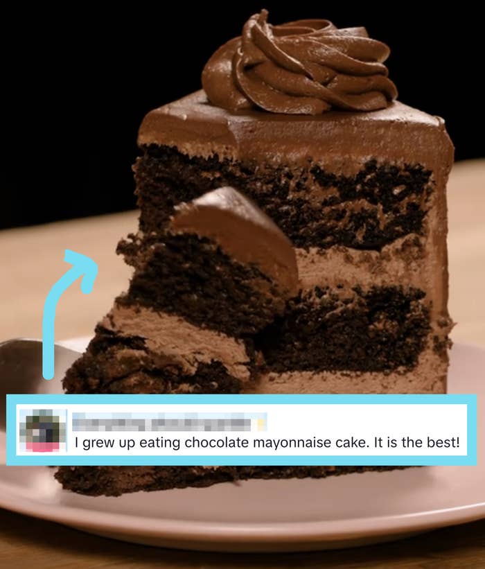 A portion    of layered cocoa  barroom   with a forkful taken out, displayed connected  a plate