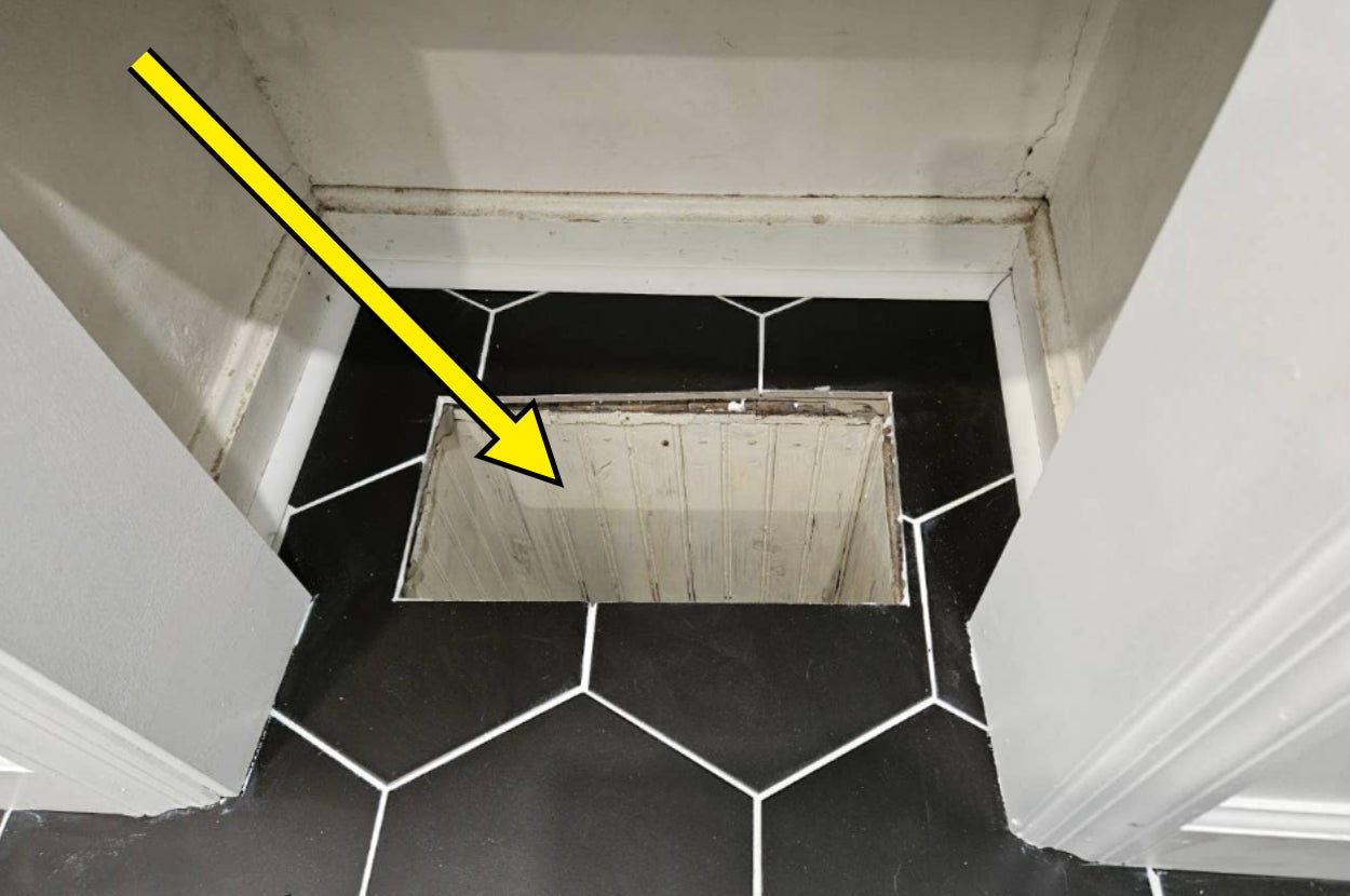 A hidden storage compartment in a tiled floor with an arrow pointing to it, suggesting a DIY home hack or clever space-saving solution