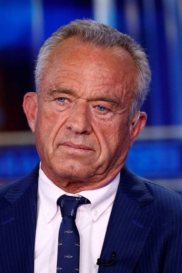 I don't know who this is, but he is wearing a blue pinstripe suit and a white shirt with a patterned tie in a formal setting