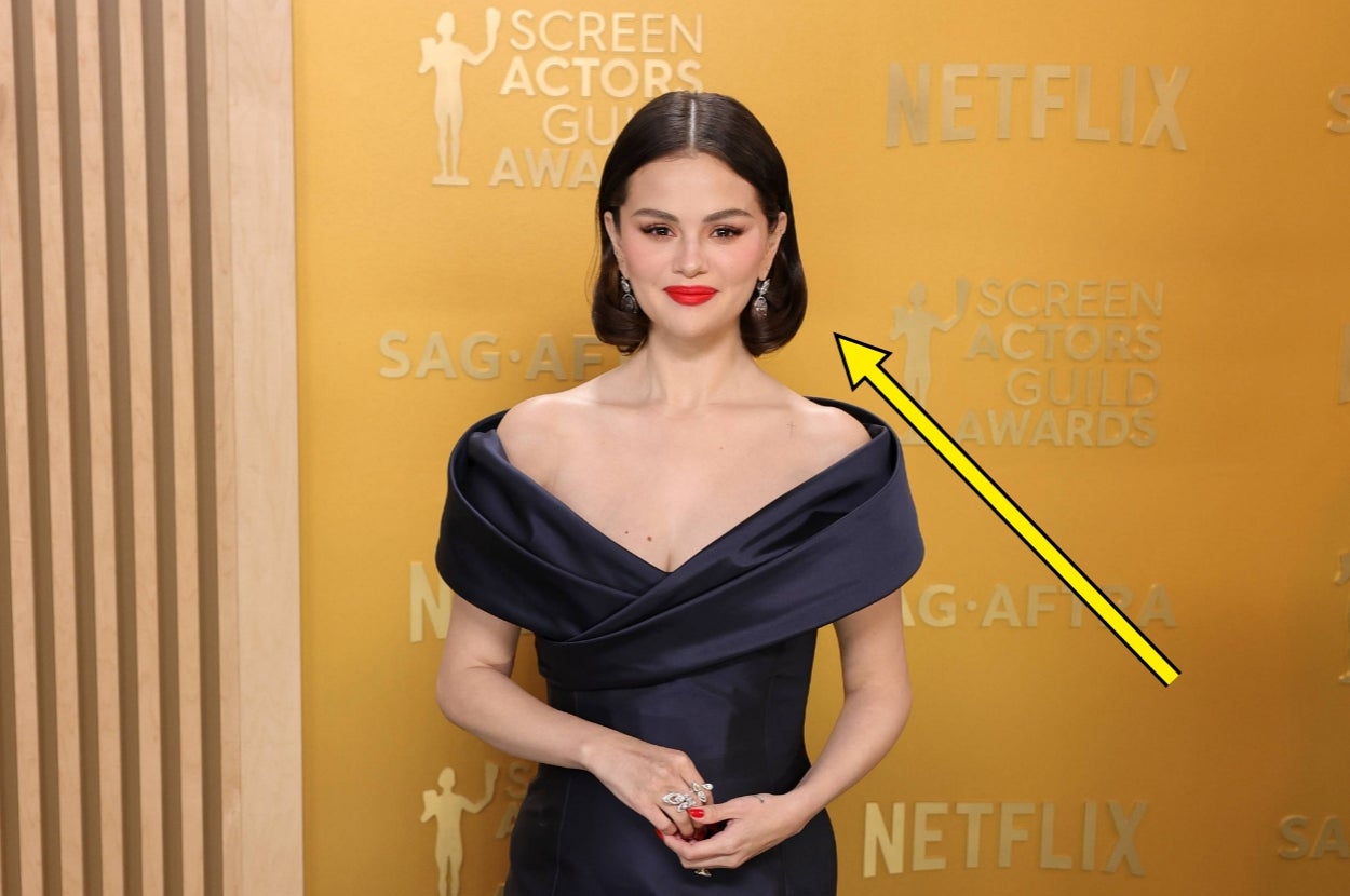 Person in an elegant off-the-shoulder gown at the Screen Actors Guild Awards red carpet, posing with hands clasped
