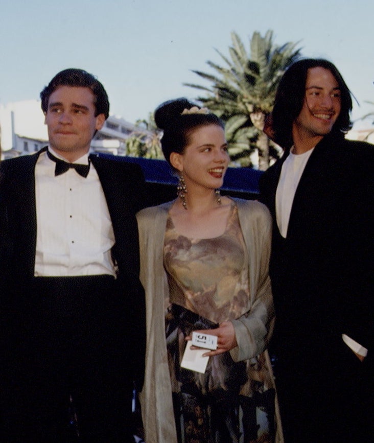 Robert and Keanu in tuxes on either side of Kate in a pattered dress with cardigan