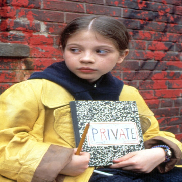 Young girl wearing a yellow raincoat, sitting on a bench outdoors, holding a notebook labeled "Private."