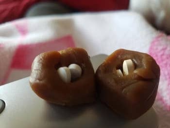 Two tiny brownish treats with pills inserted successful the halfway are placed connected a surface
