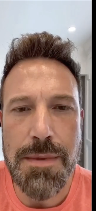 A idiosyncratic   with a beard and abbreviated  hair, wearing a casual shirt, looks into the camera. The inheritance  is simply a elemental  indoor setting