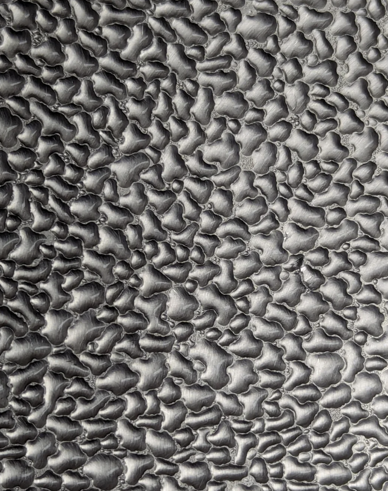 Textured metallic  aboveground  with a signifier   resembling irregular, integrated  shapes