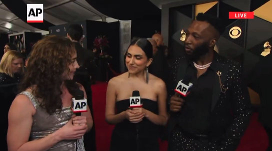  one in a sparkly suit, the other in a strapless dress