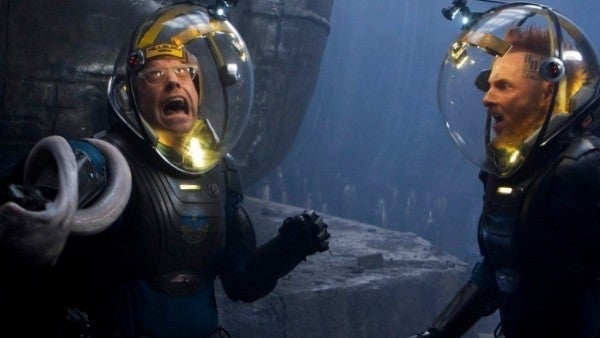 Two people wearing space suits with helmets confront a mysterious creature in a sci-fi setting