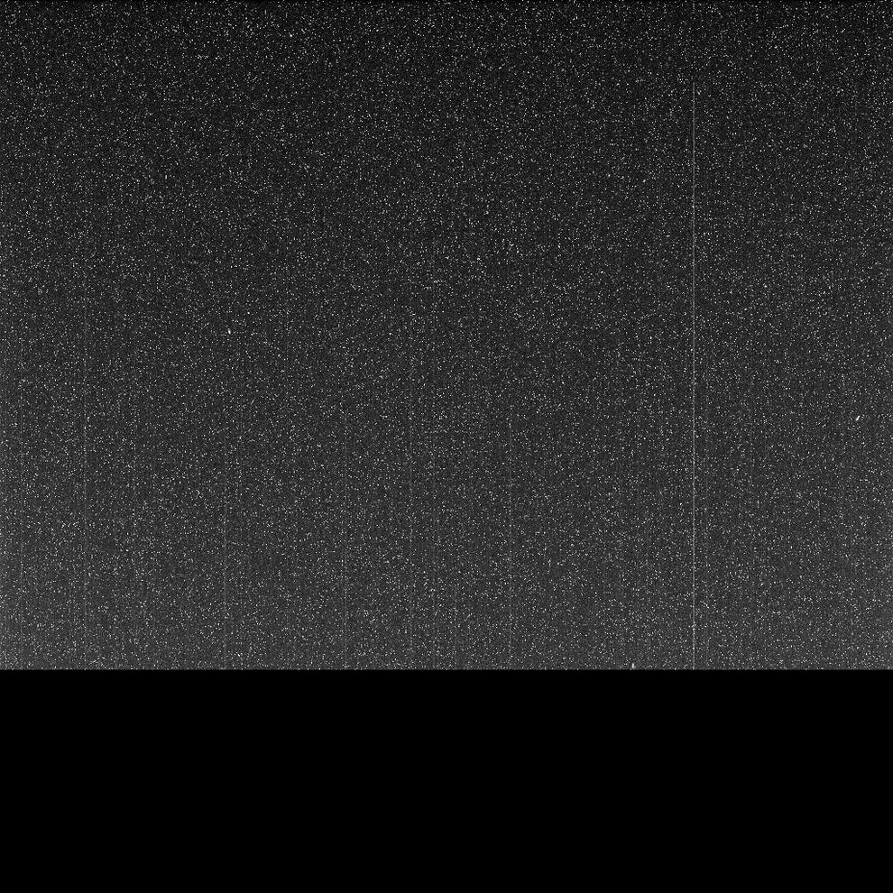 Static noise pattern resembling an old TV screen with random speckles scattered across a dark background