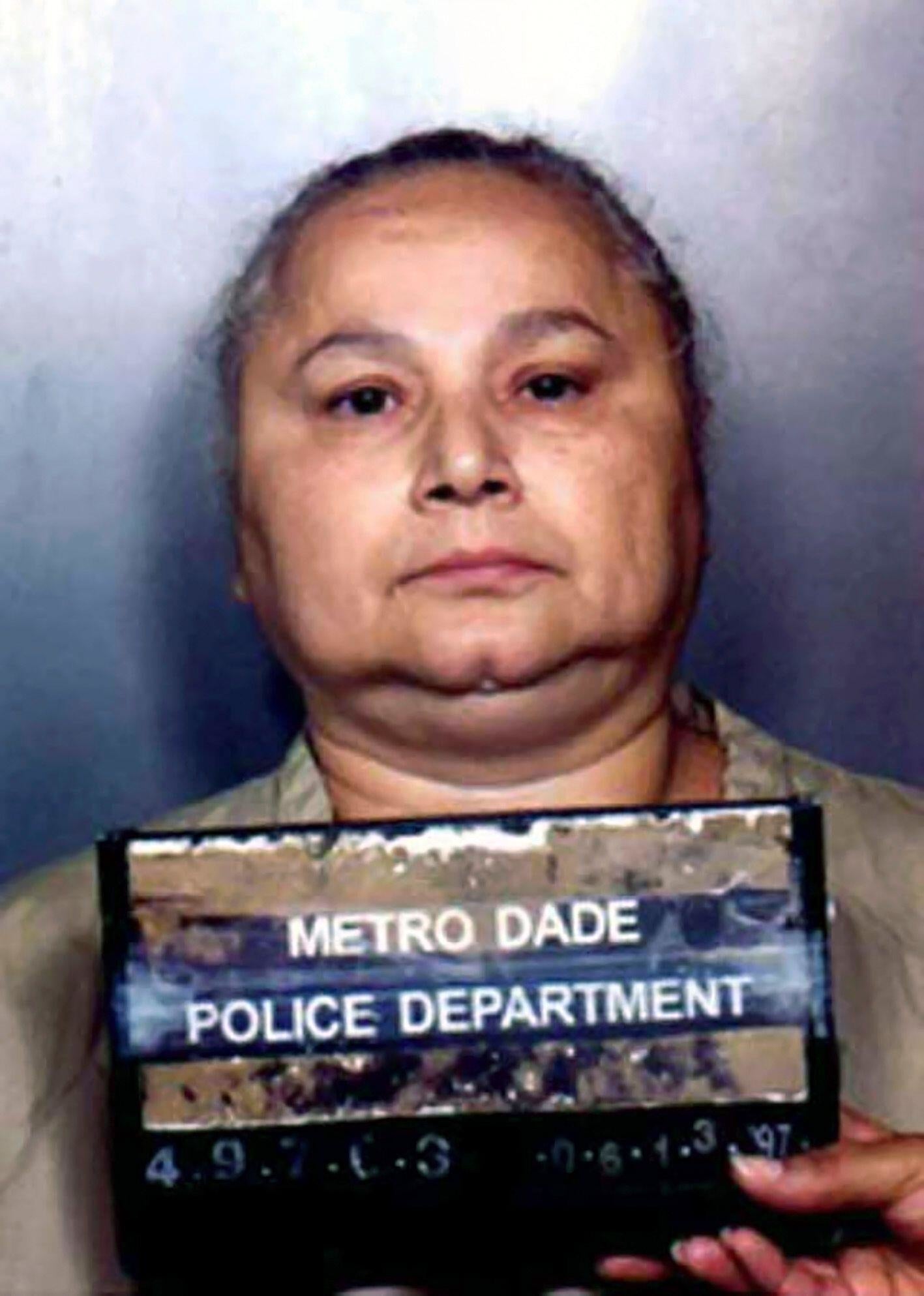 Person holding a Metro Dade Police Department placard for a mugshot
