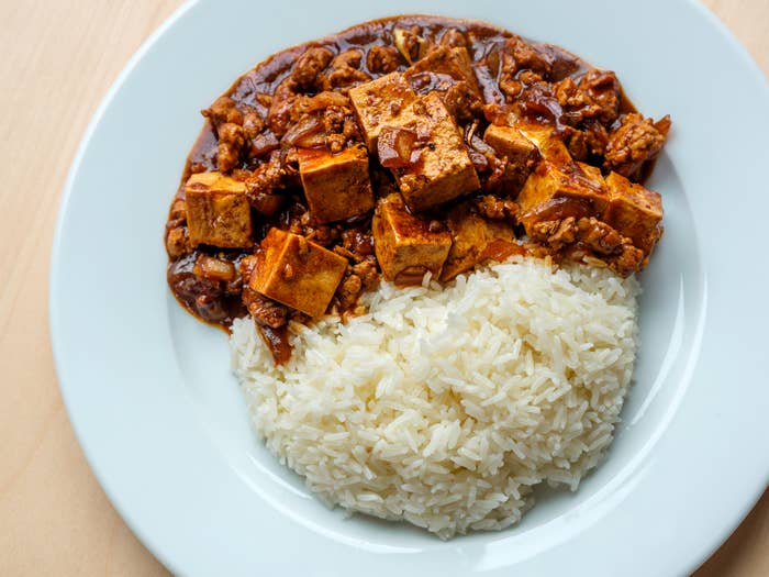Plate with mapo tofu and white rice served side by side