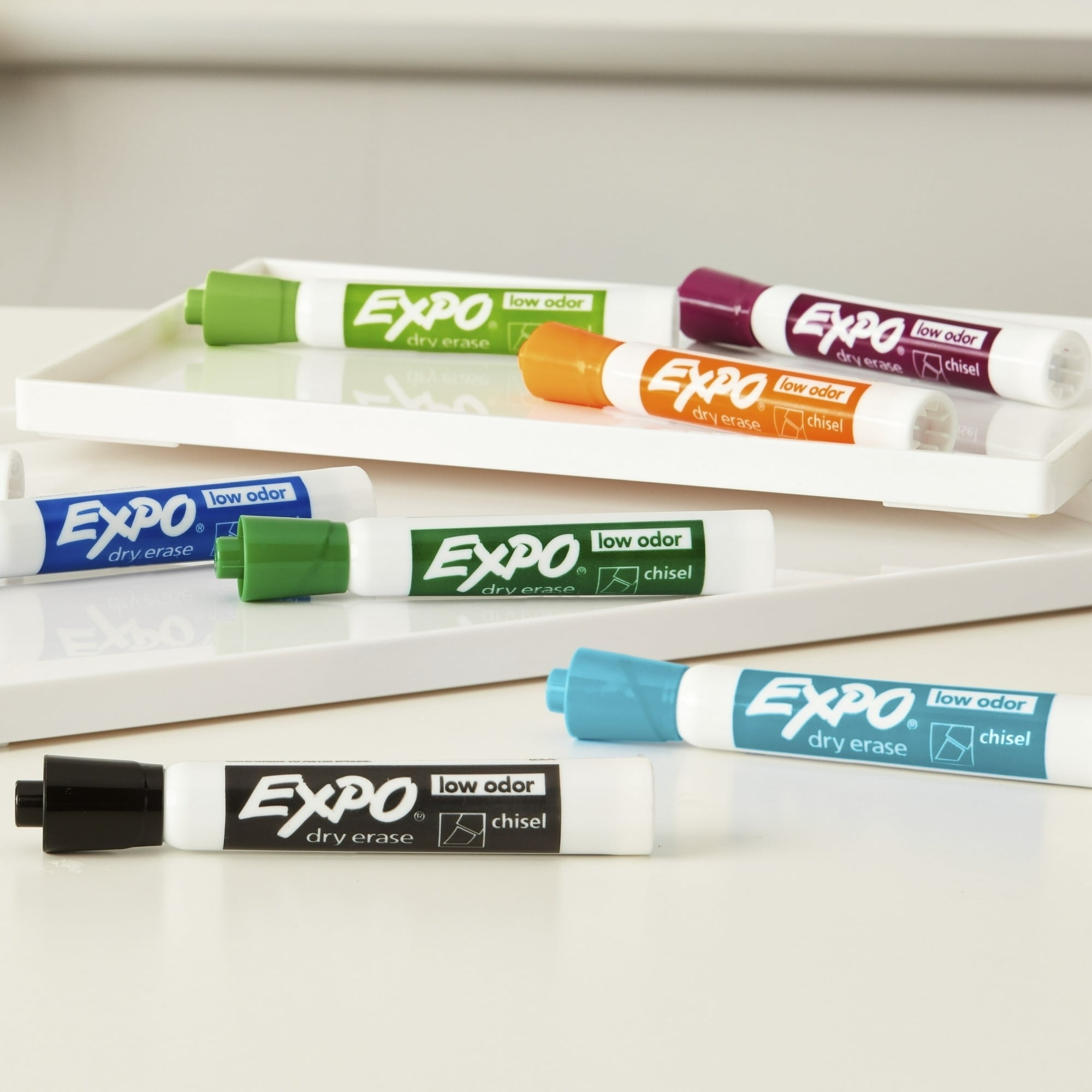 Expo dry erase markers with chisel tips in various colors are displayed on a table