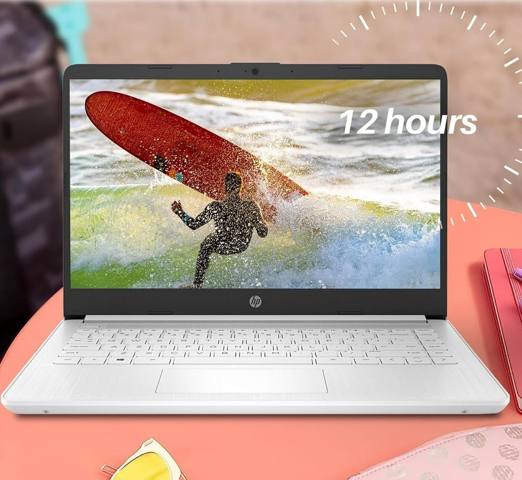 Laptop on table with a screen displaying a surfer. Text highlights 12-hour battery life, 11.5 hours video playback, and 9 hours wireless streaming