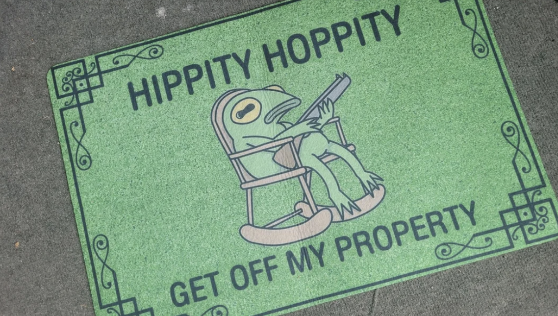 Doormat with a laid-back frog sitting in a rocking chair holding a rifle, text reads "Hippity Hoppity Get Off My Property."