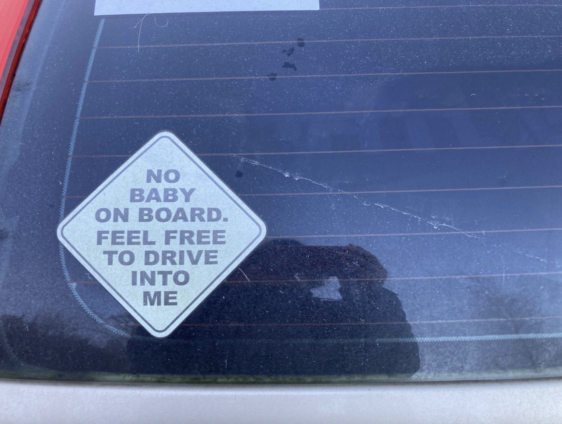 Car sticker reads: "No baby on board. Feel free to drive into me."