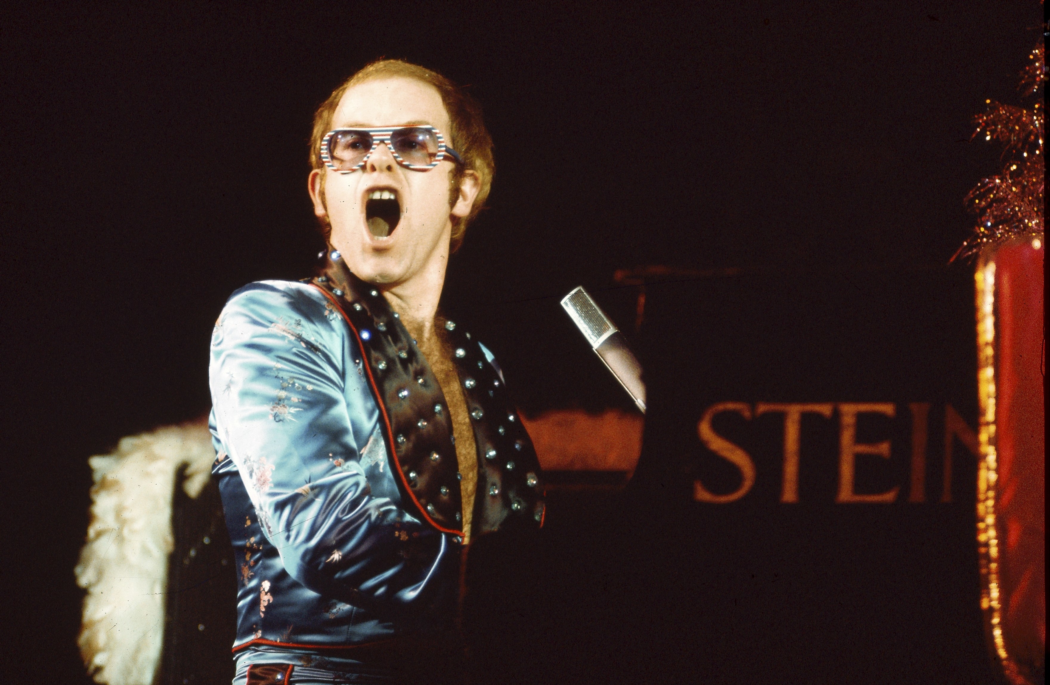 Elton John performing on stage.