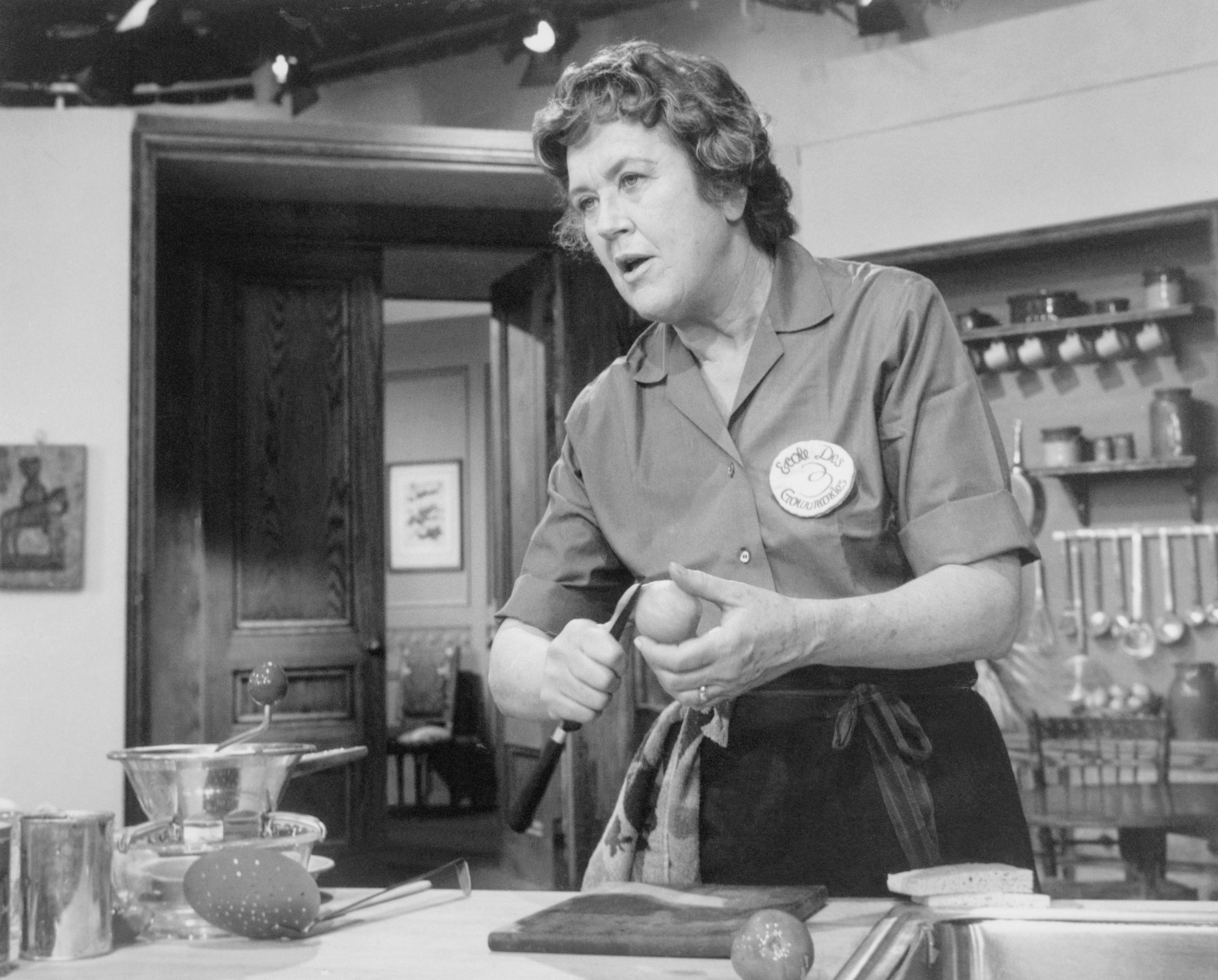 Julia Child preparing a dish.