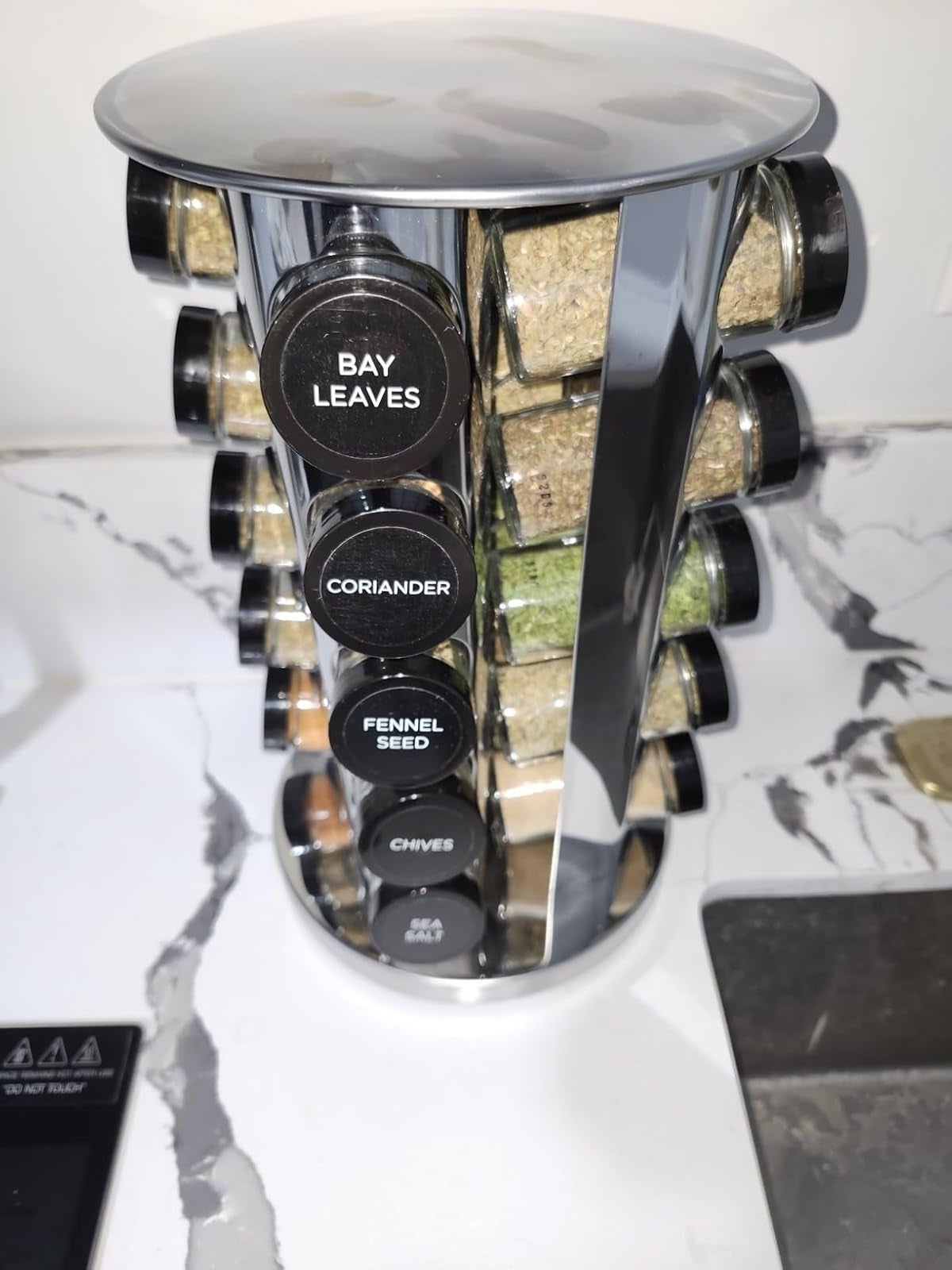 Rotating spice rack with labeled jars of spices