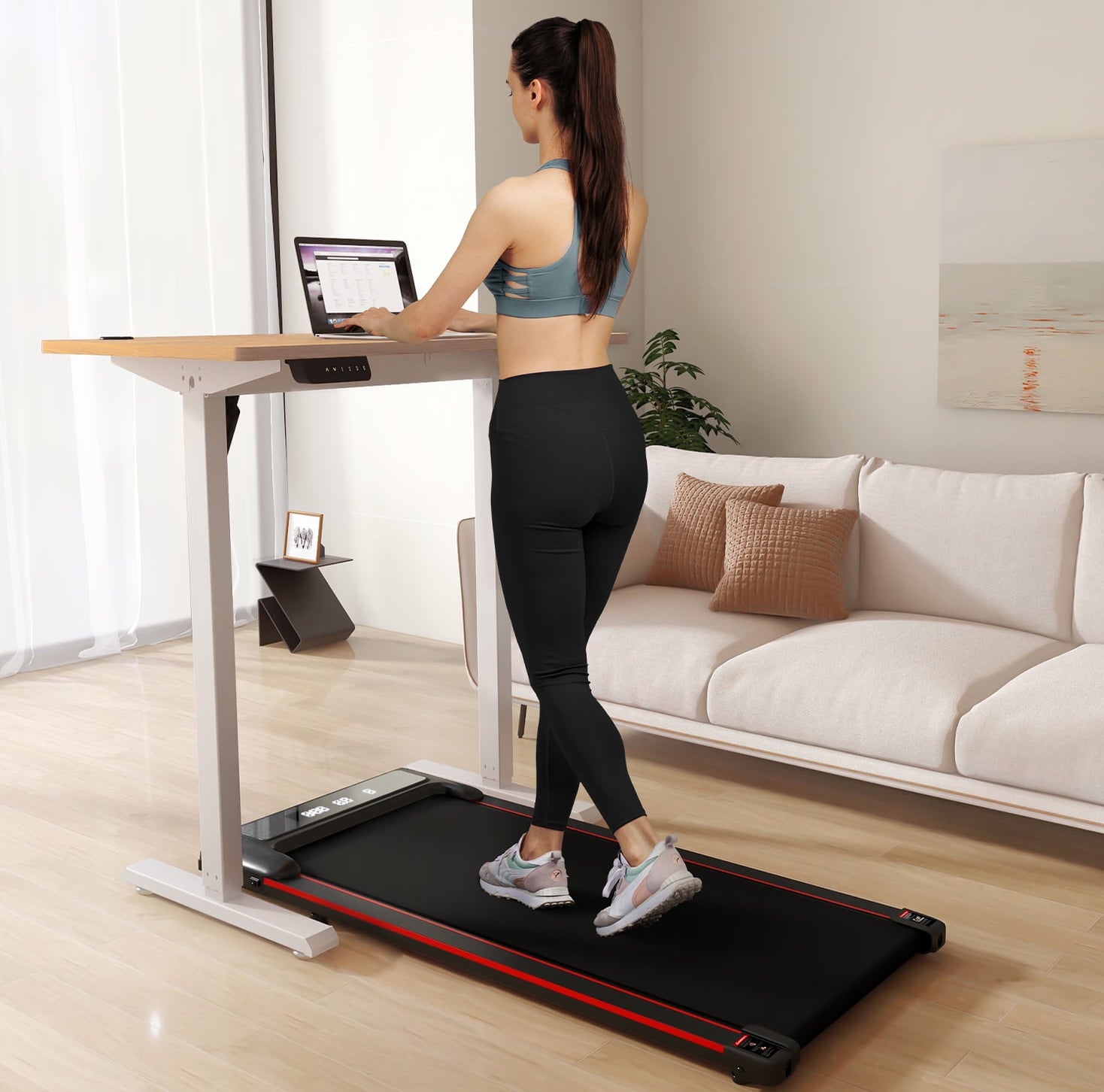 Person walking on a treadmill desk in a modern living room, suggesting a healthier home experience