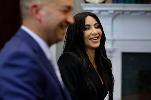 Kim Kardashian smiling in a formal setting