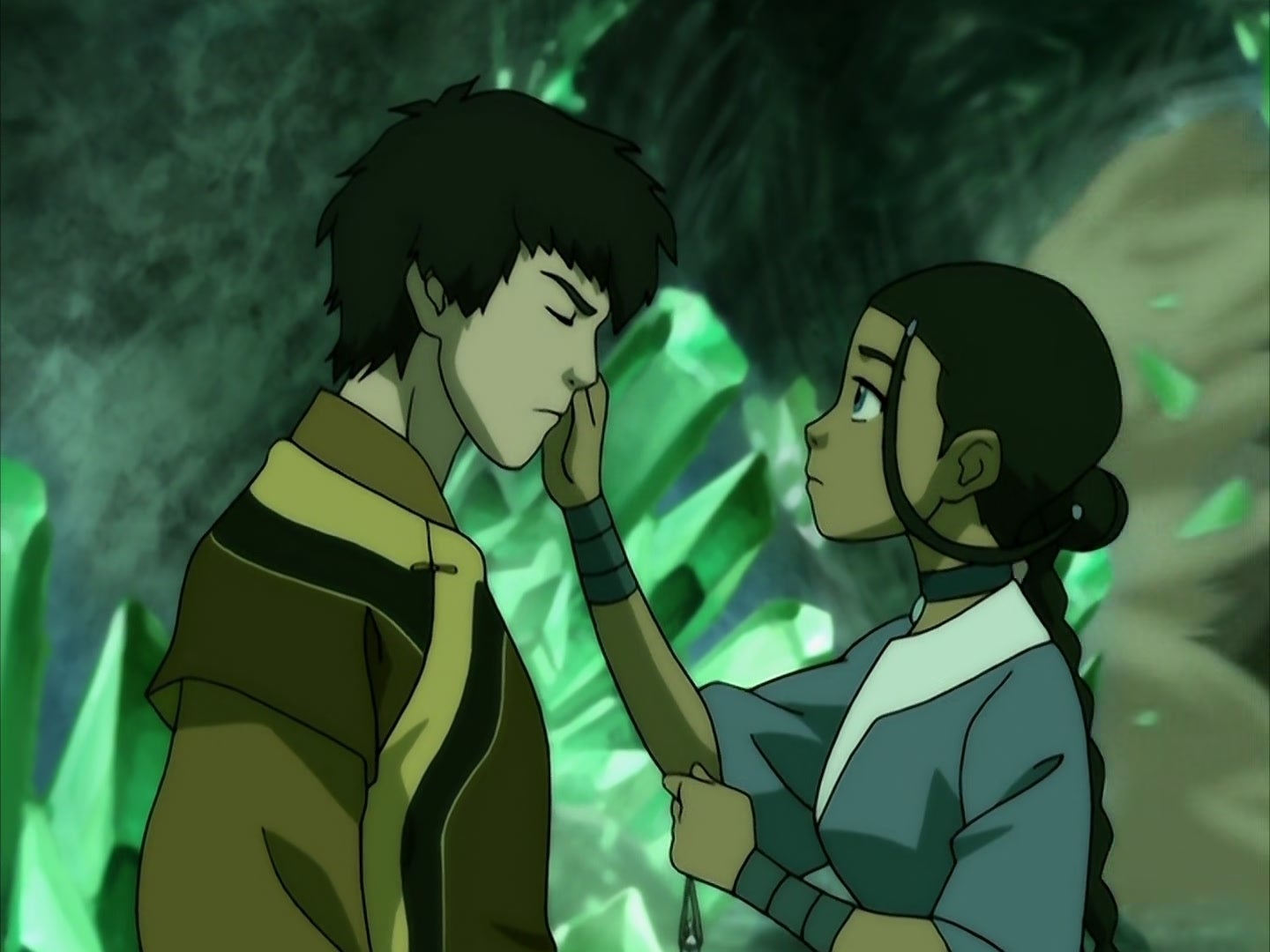  a character in brown clothing looks emotional as a character in blue gently touches their face