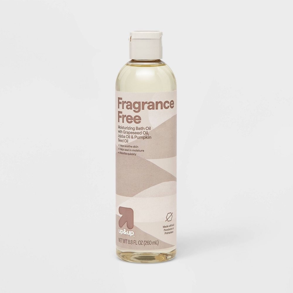Bottle of fragrance-free moisturizing bath oil with grapeseed, shea, and pumpkin oils, labeled for sensitive skin, 8.8 fl oz