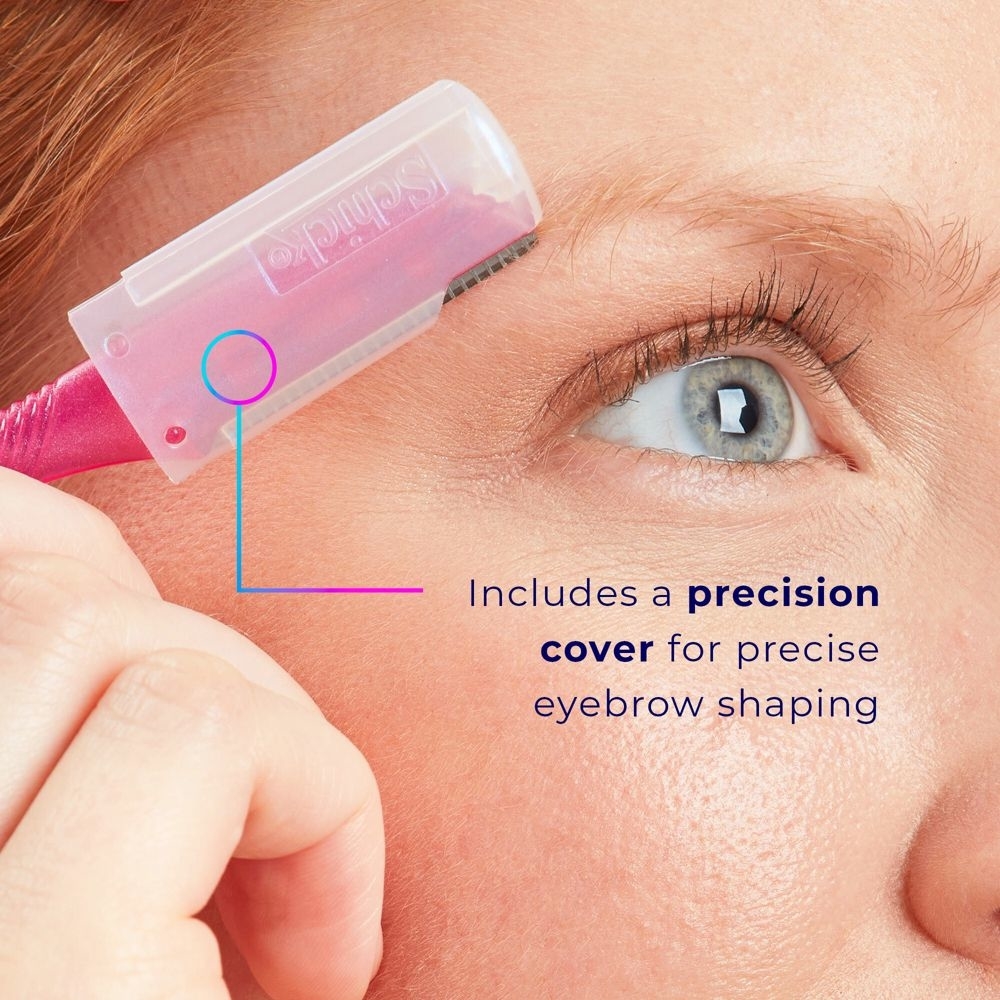 Close-up of a person using an eyebrow razor with a precision cover for shaping eyebrows, highlighting the tool's accuracy