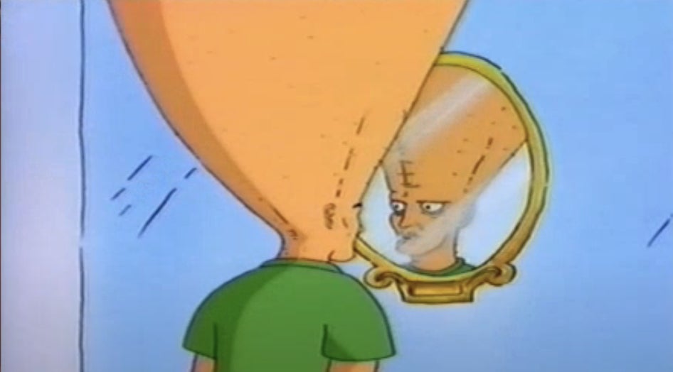 Cartoon character with a tall, cone-shaped head looks at reflection in a mirror, wearing a simple outfit